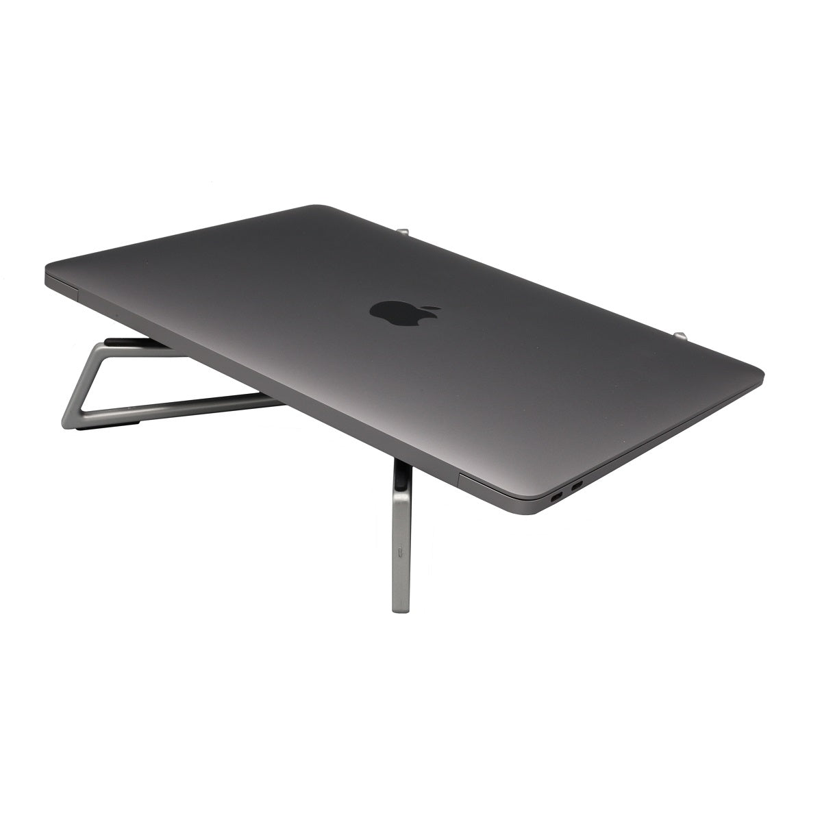 The silver FlexVerk portable laptop stand is shown holding a closed Macbook Air on a white background.